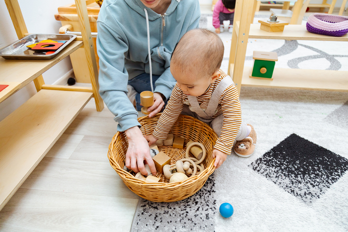 Mother and toddler playing with montessori toys