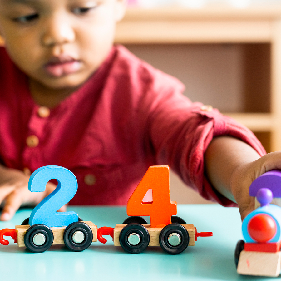 little boy playing with number cars at Von's Kids child care